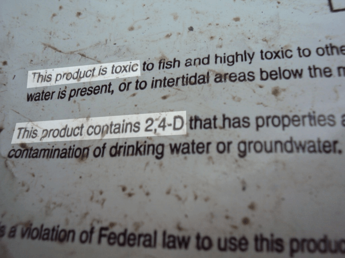 Warnings on Vassar's bags of pesticides, with 2,4-D information highlighted.