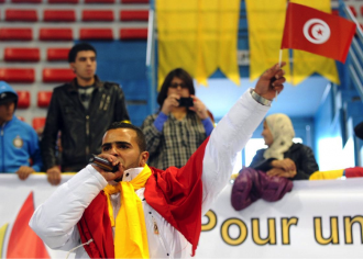 Tunisian artist El Général (Hamada Ben Amor), raps at a Tunisian opposition rally. 
Fethi Belaid/AFP/Getty Images